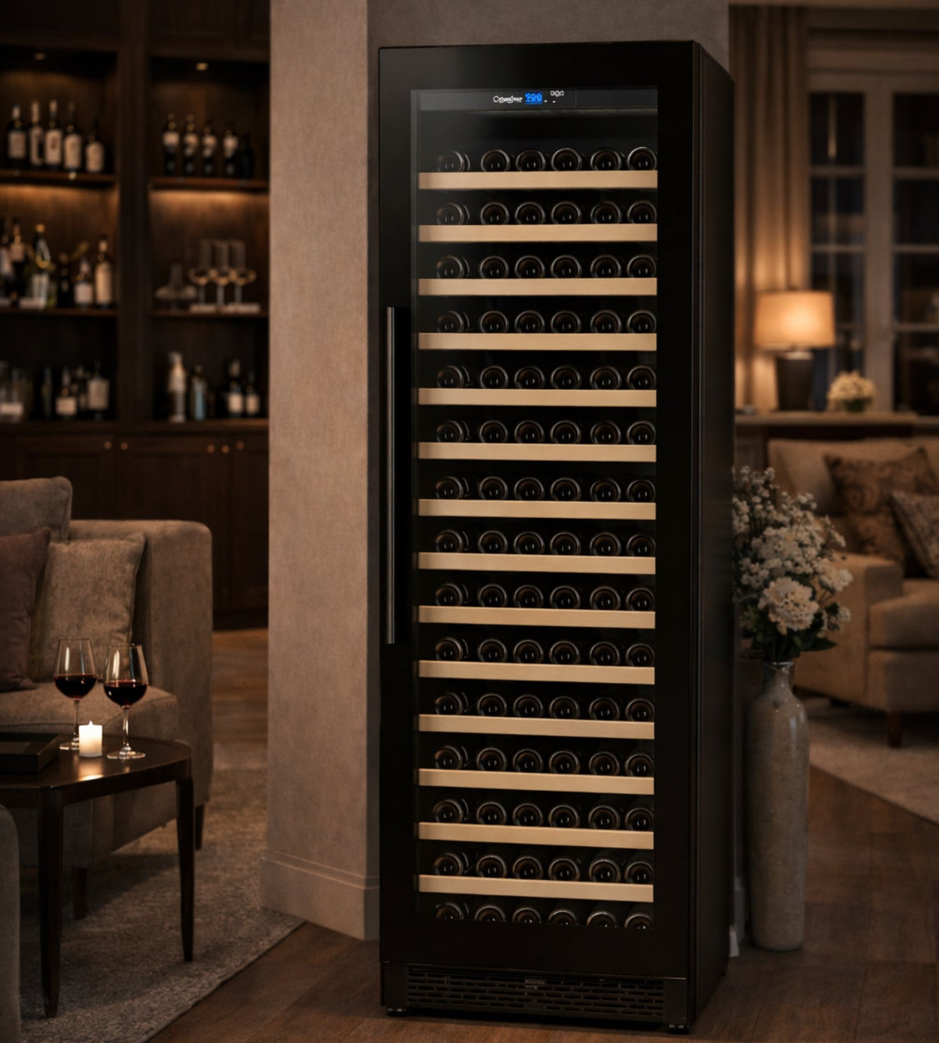 Tall black wine cooler in a dimly lit room with wine bottles on shelves.