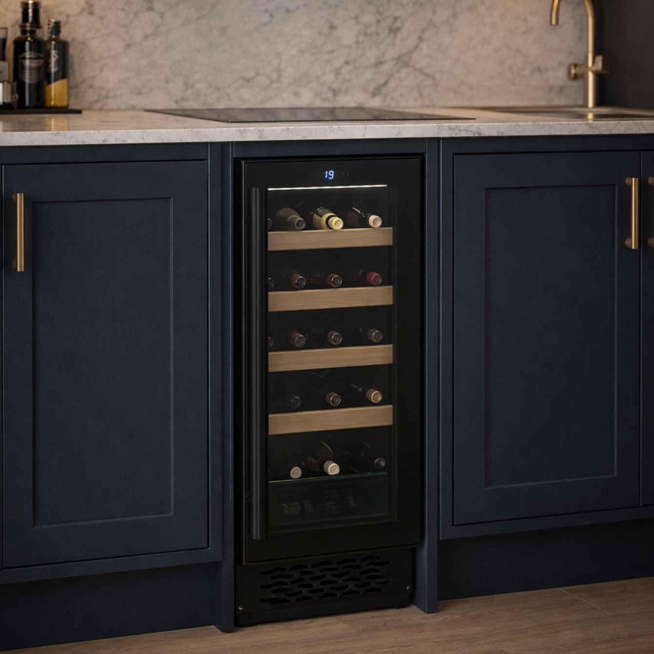 Wine cooler integrated into a kitchen with dark cabinets and marble backsplash.