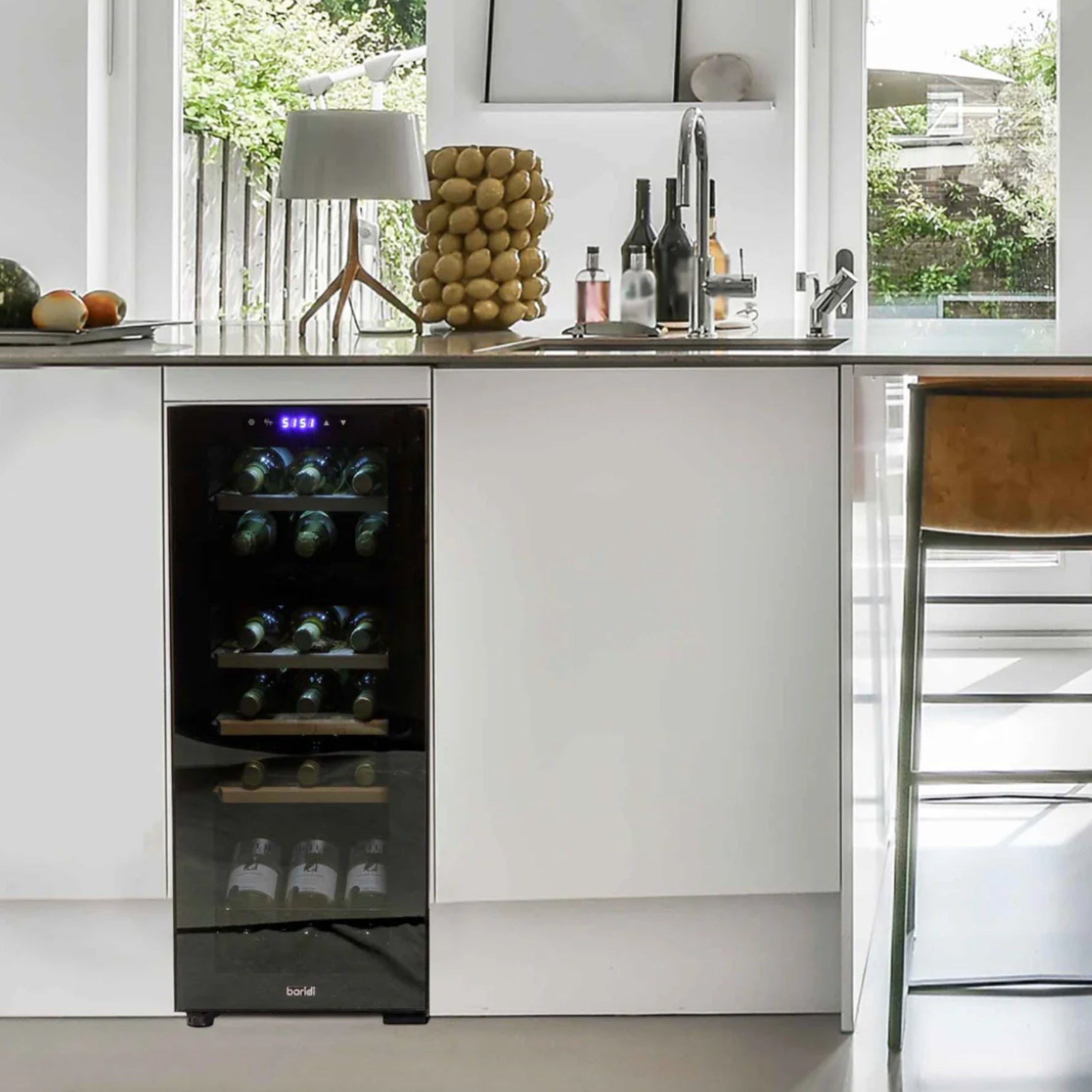 Modern kitchen with a built-in wine cooler and a bar stool.