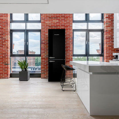 Modern kitchen with black refrigerator, white island, and brick walls.