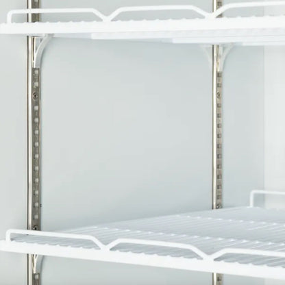 Metal shelving unit with white wire shelves on a plain background