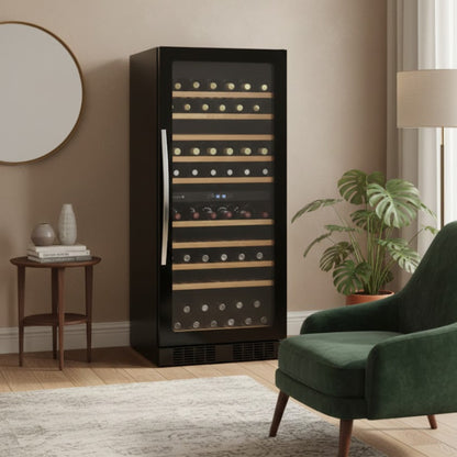 Black wine cooler in a modern living room with a green armchair and plant.