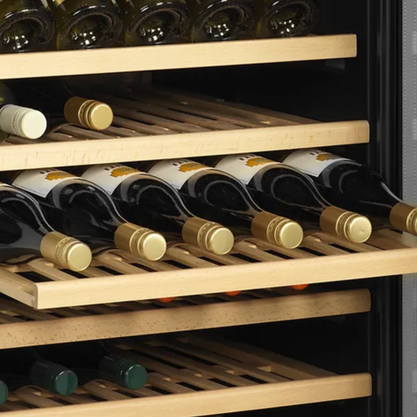 Wine bottles arranged on wooden shelves inside a wine cooler.